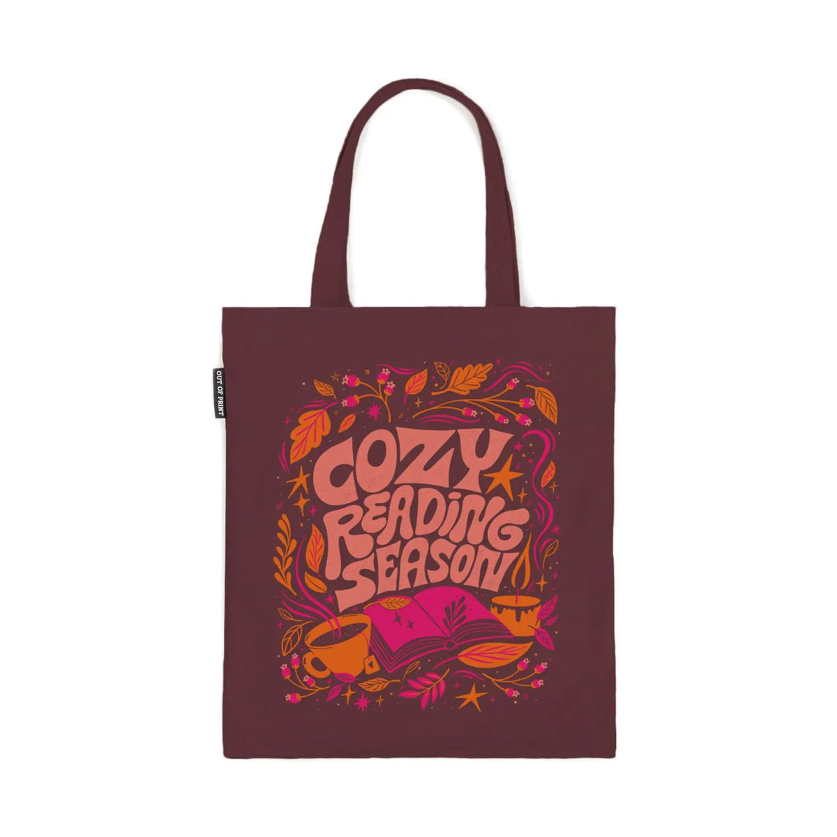 A dark burgundy tote with "Cozy Reading Season" in large letter surrounded by leaves, an open pink book, and a yellow cup of coffee against a white background.