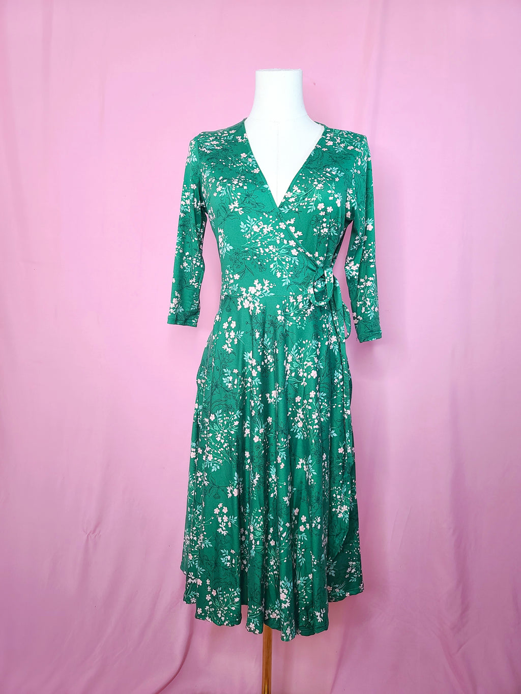 Front of dress on a white mannequin against a pink background
