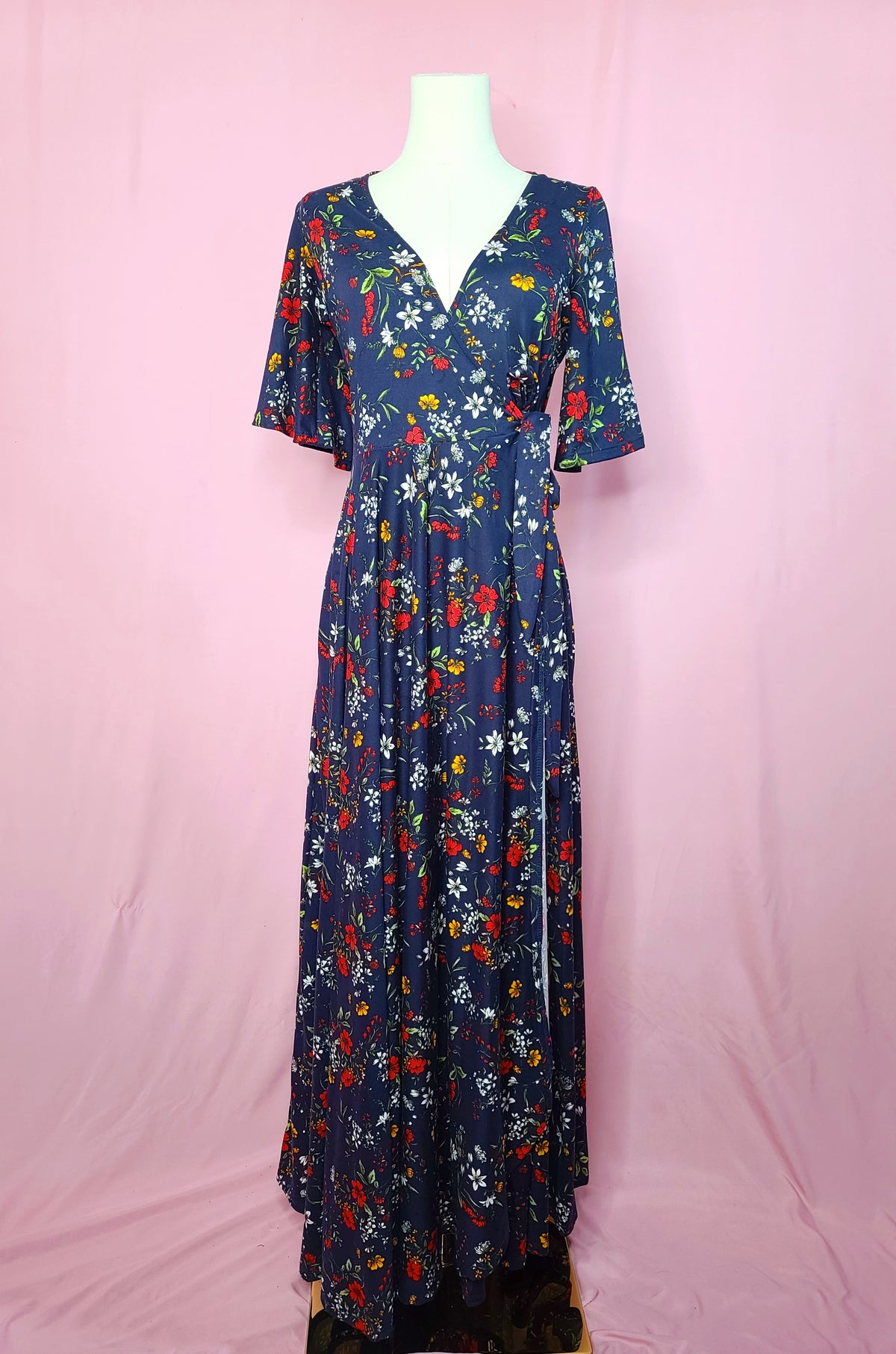 Front of dress on a white mannequin against a pink background