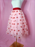 Skirt on a white mannequin against a pink background.