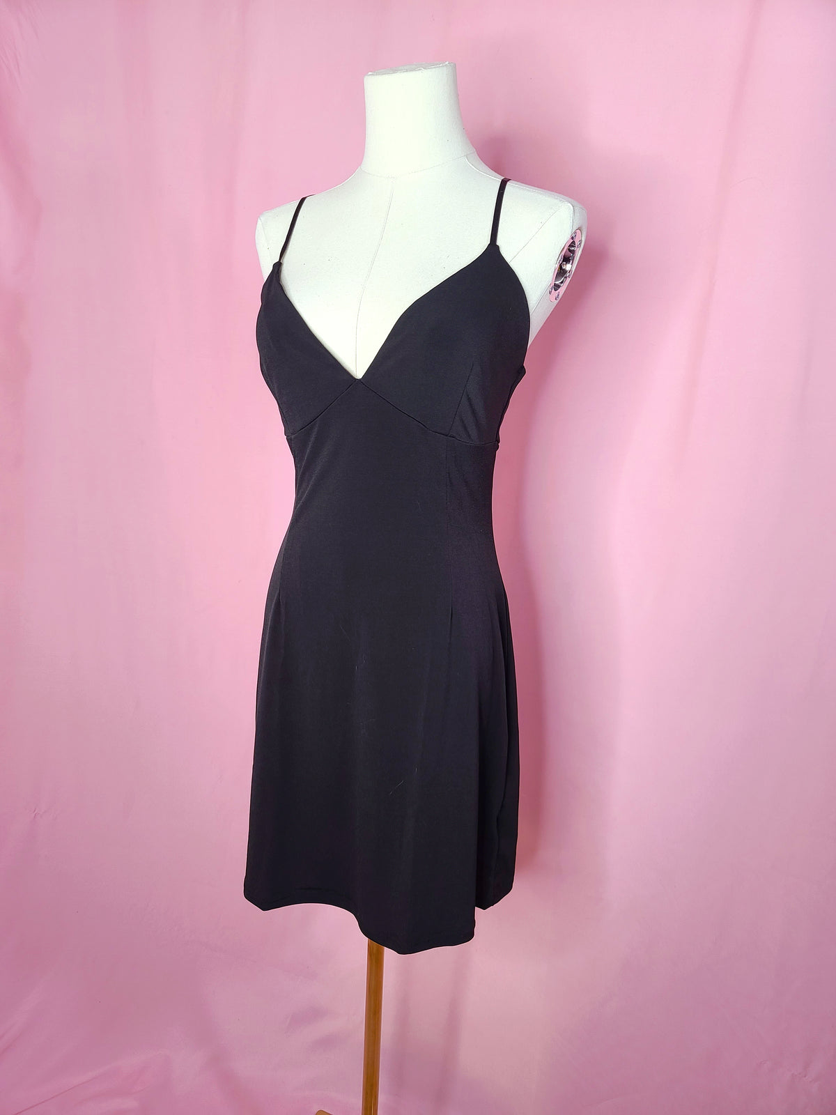 Slip on a white mannequin against a pink background