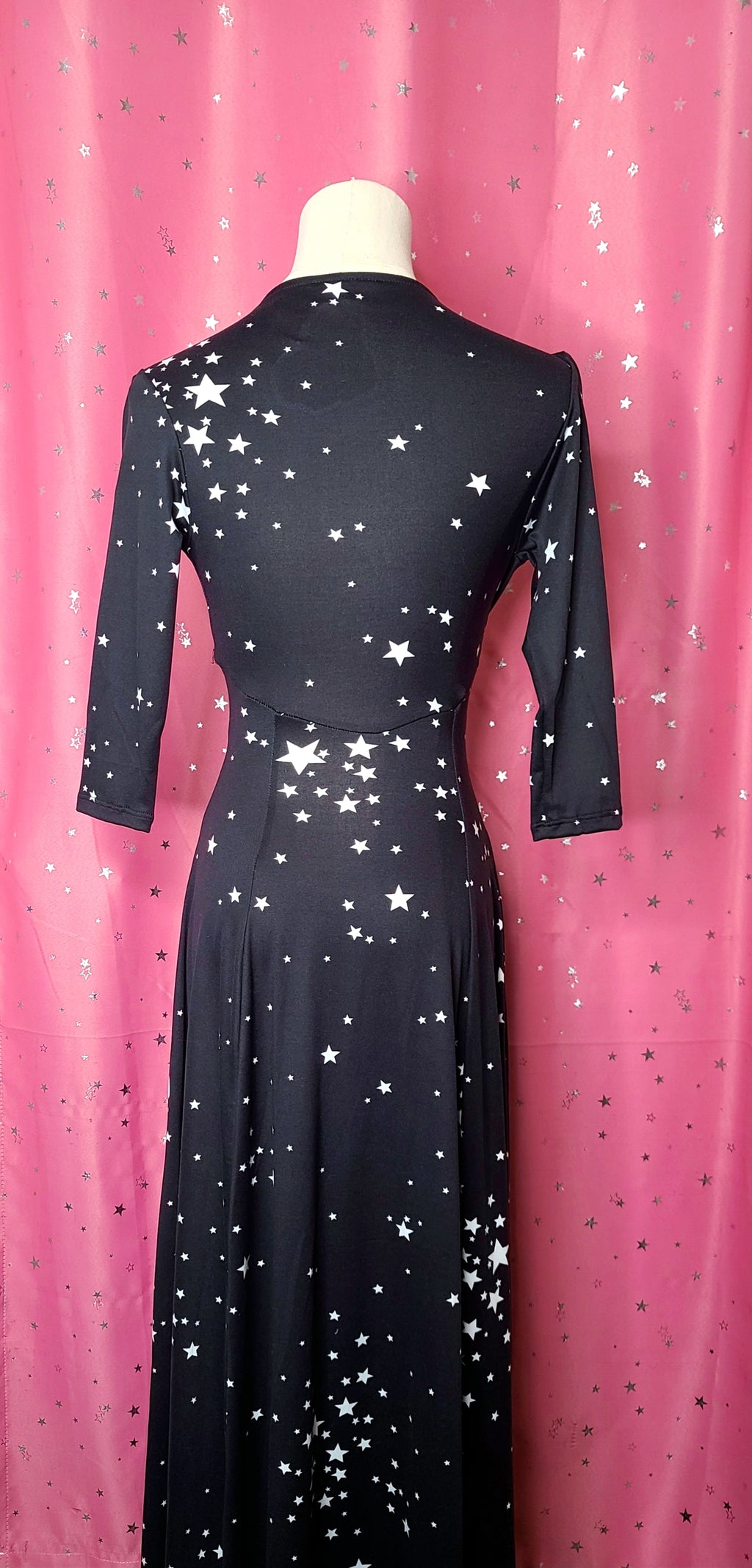 Back of dress against a pink background 