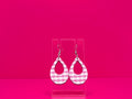 Light punk gingham tear drop earrings on a clear display against a hot pink background.