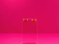 Devil horned heart earrings on a clear disay against a pink background.