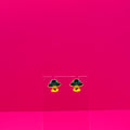 UFO abducting cows on a clear stand against a pink background.