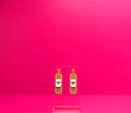 Brown bandage earrings on a clear display against a pink background.