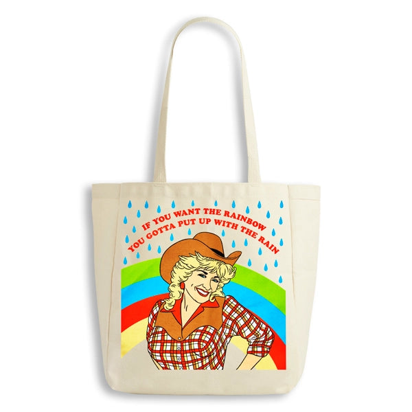 Tote bag with a graphic of Dolly Parton in a cowboy hat and rainbow, featuring text.