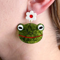 Close up of earring worn by a model with fair skin.