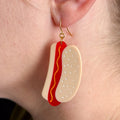 Close up of earring on a model with fair skin.