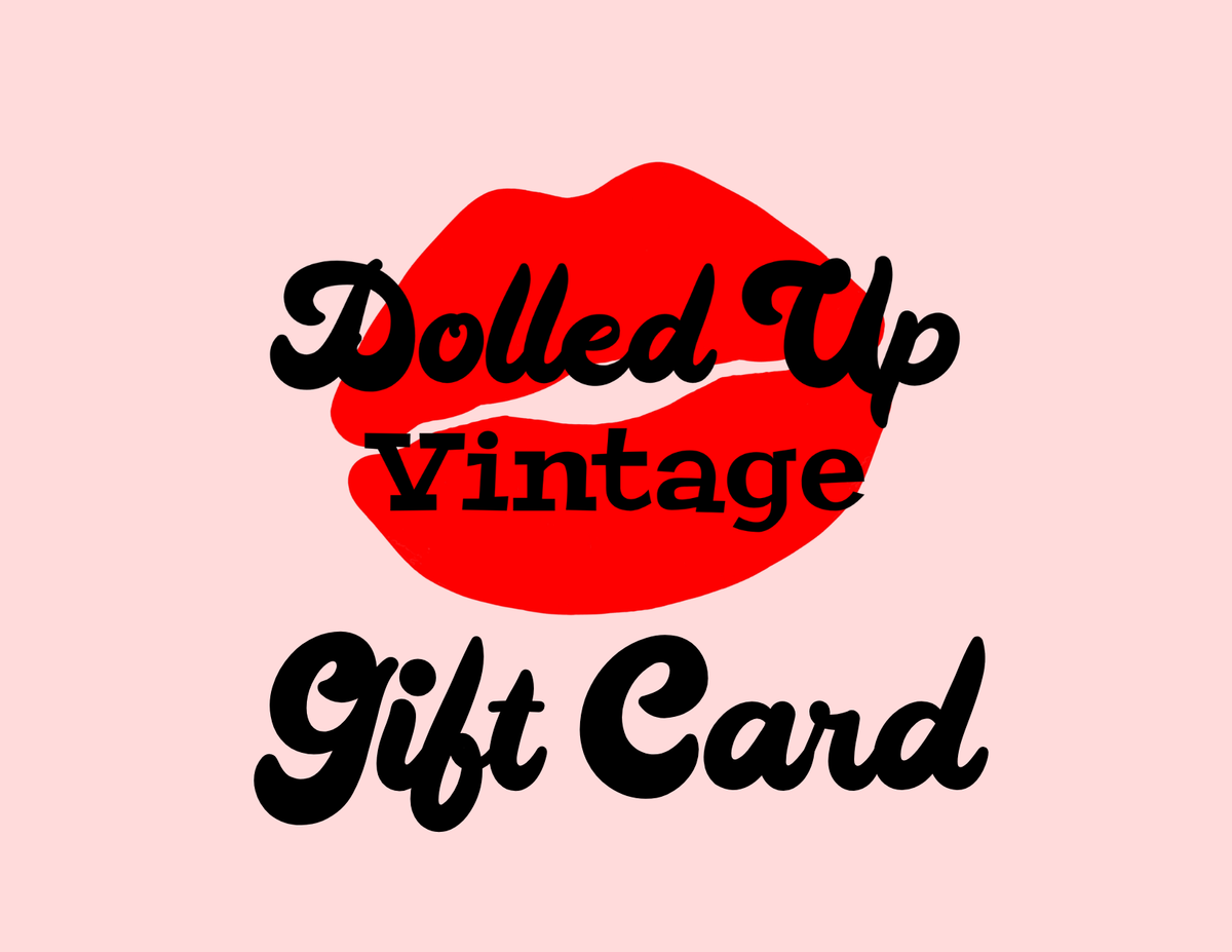 "Dolled Up Vintage" in black font against red lipstick print with the phrase "Gift Card" below against a pink background.