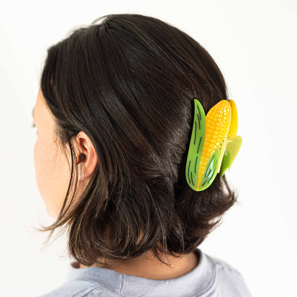 Brunette model with hair claw in hair against a white background.