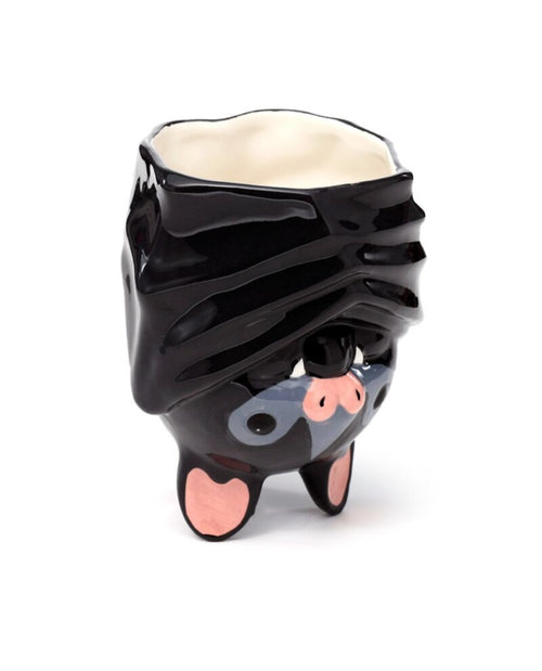 Black bat-shaped mug with a white interior on a white background