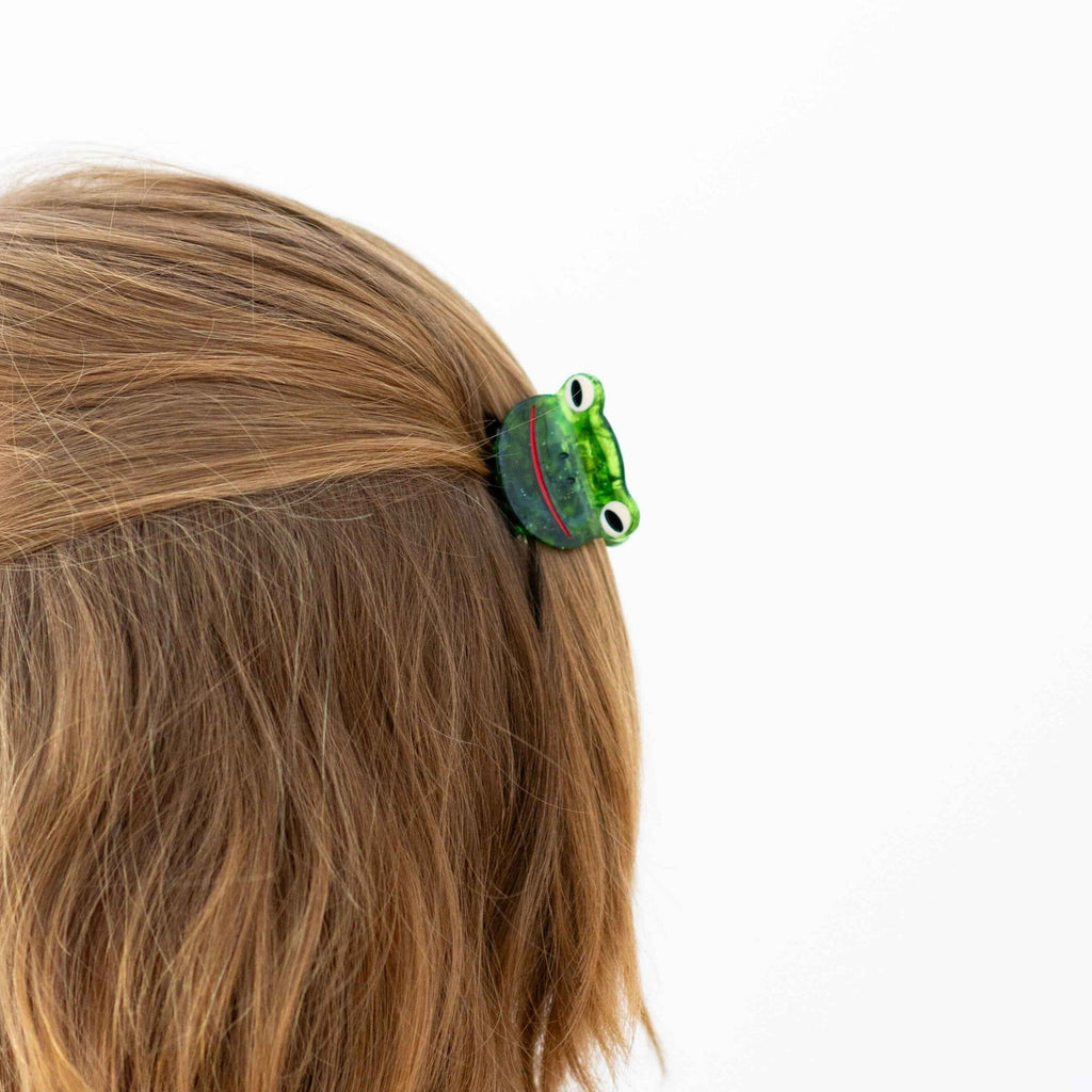 Close up of hair claw in brunette model's hair against a white background.