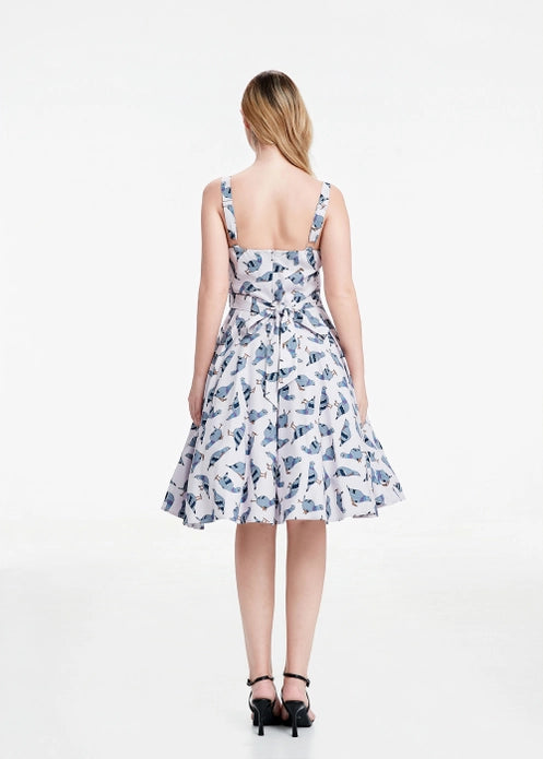 Woman wearing pigeon dress showing the back against a white background.