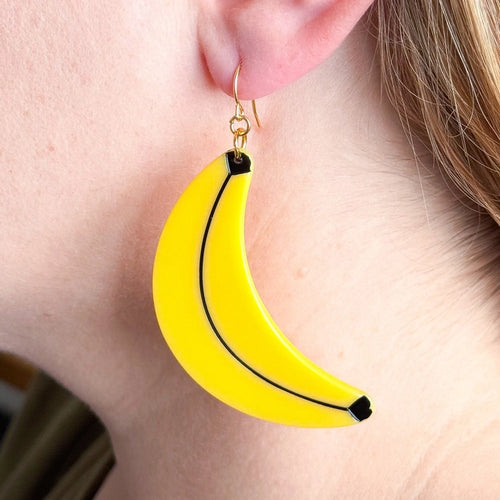 Close up of earring being worn by model with fair skin.