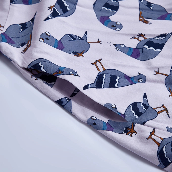 Close up of pigeons on the dress against a white background.