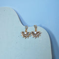 Earrings against a white and blue background