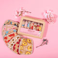 Makeup erasers and box against a pink background